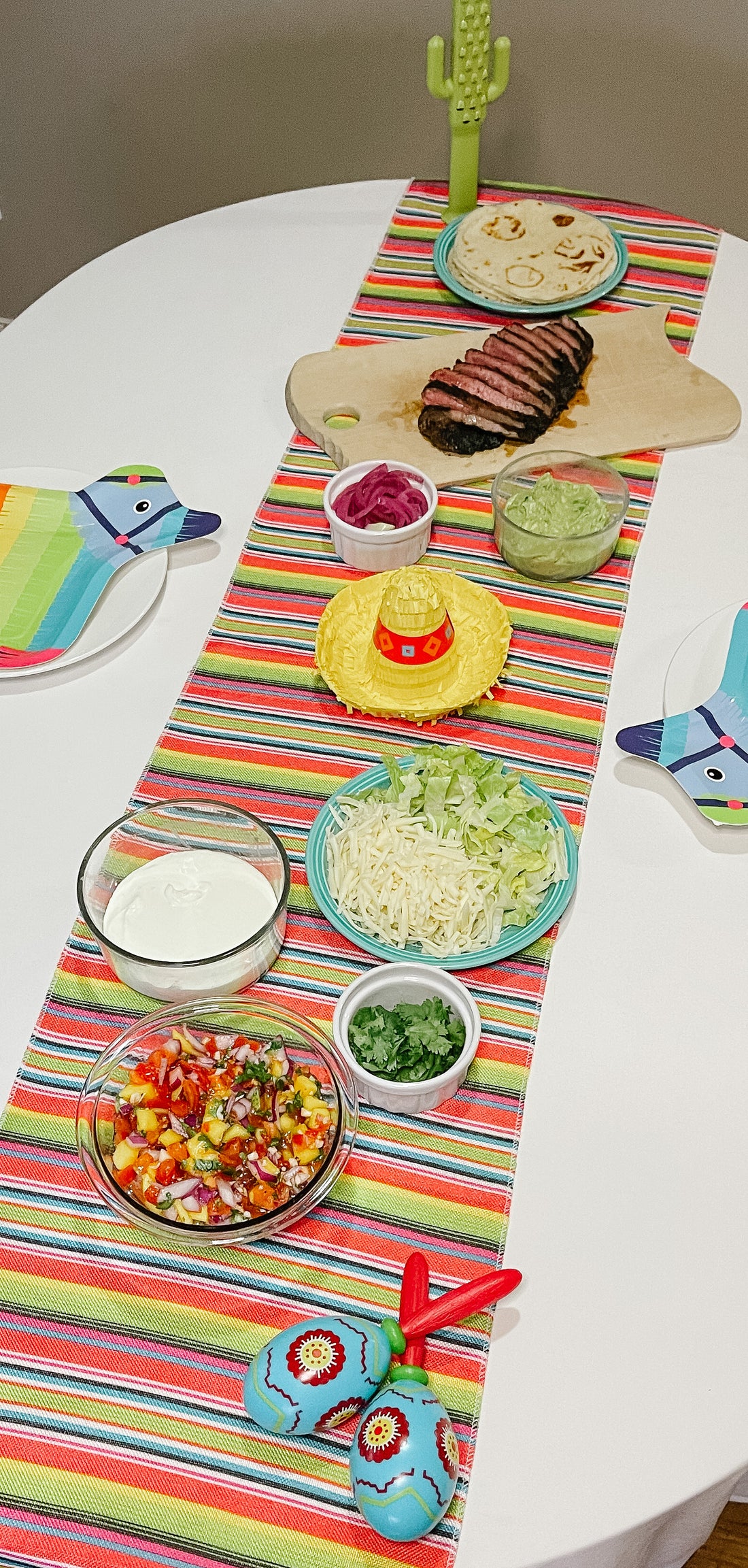 It's a Fiesta!  A Cinqo de Mayo feast on a festive table.  Carne Asada Beef, Tortillas and all the fixin's!